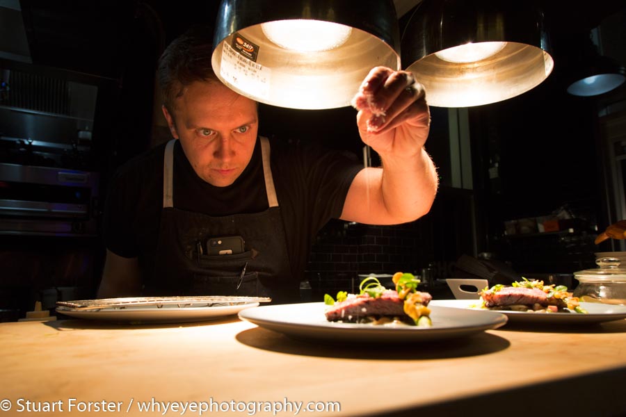A dark background and brightly lit foreground in Shokunin, one of Canada's top restaurants.
