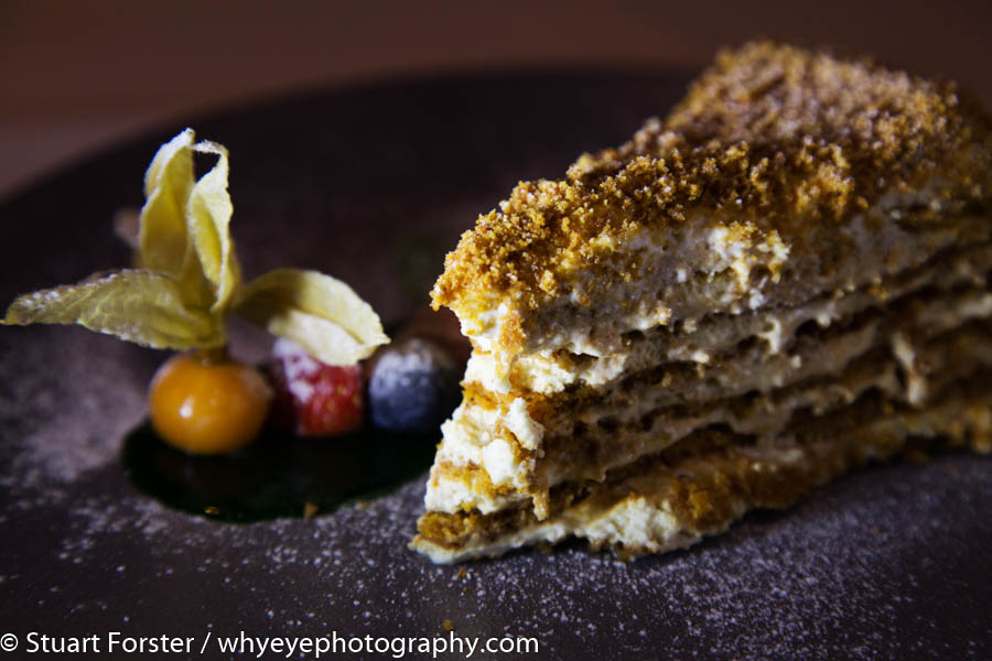 Layered honey cake served with fresh fruit, an exampls of Latvia travel photography and food images capture by Stuart Forster of Why Eye Photography.