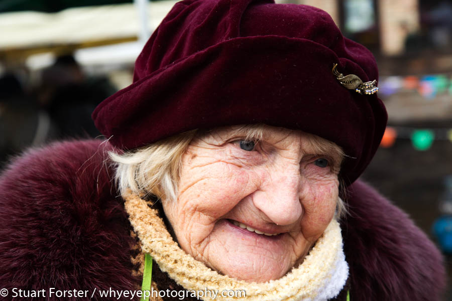 Woman wearing a hat while selling cakes at a Christmas market in Riga, Latvia