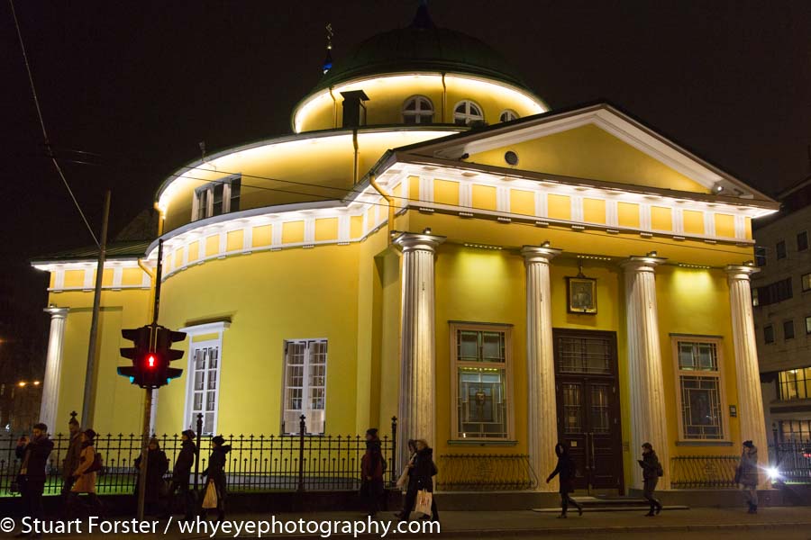 The yellow facade of Saint Alexander Nevsky Orthodox Church see at night in Riga, Latvia