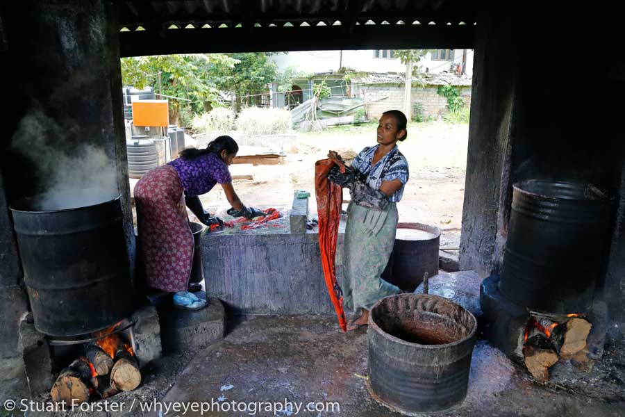 Women at work hand dying traditional batik fabric at a production unit in central Sri Lanka.
