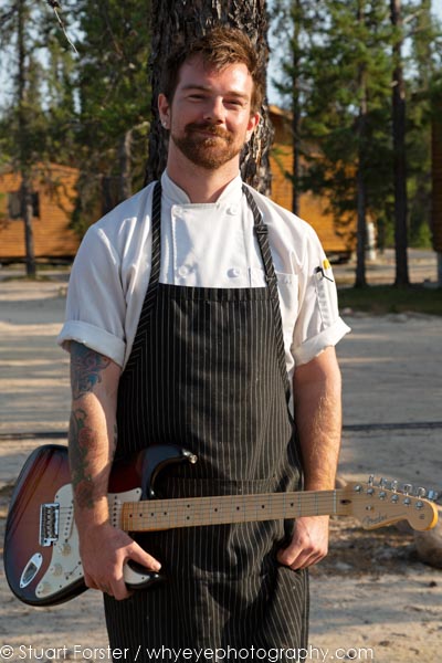 Ben, the chef at Gangler's North Seal River Lodge, holding an electric guitar.