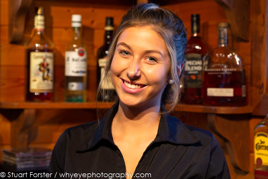 A blonde woman smiles for the camera at Gangler's Lodge in Manitoba, Canada.