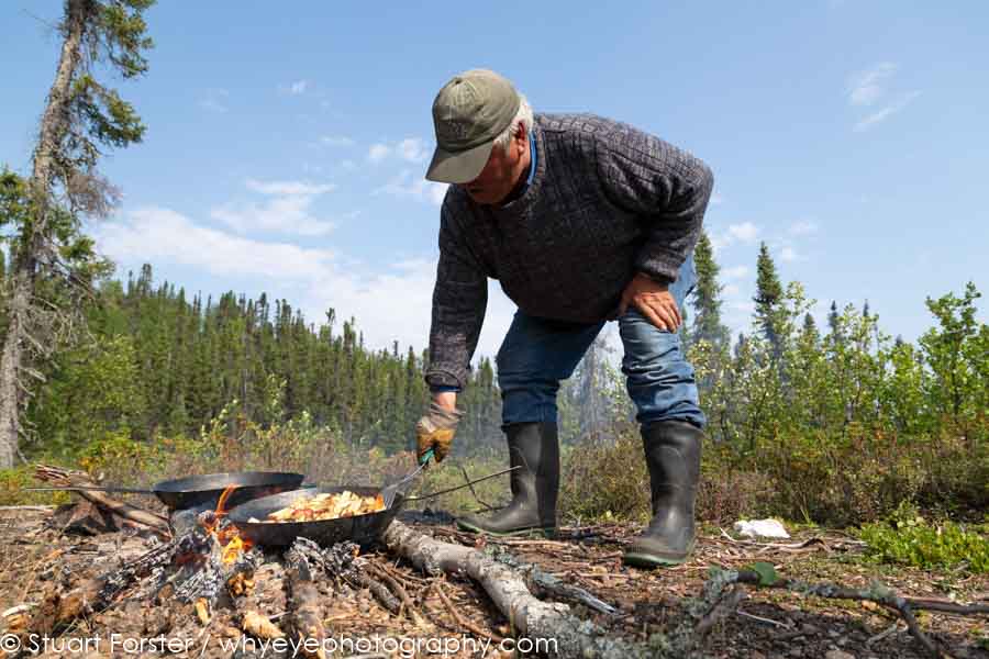 Raymond cooks a lakeside shore lunch during a day of fishing at Gangler's in Manitoba, Canada