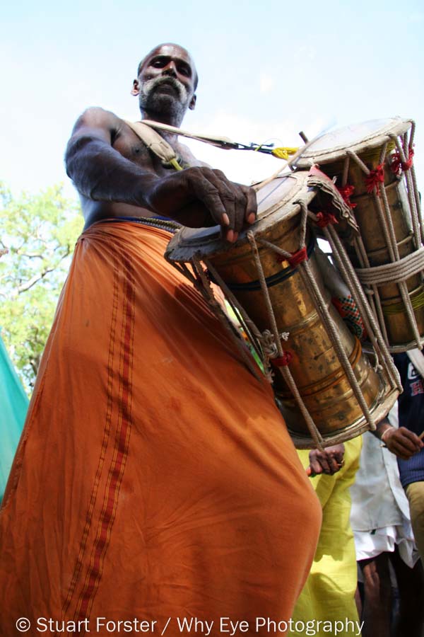 Looking up at a drummer at a festival honouring the Hindu god Murughan in Tamil Nadu, India.