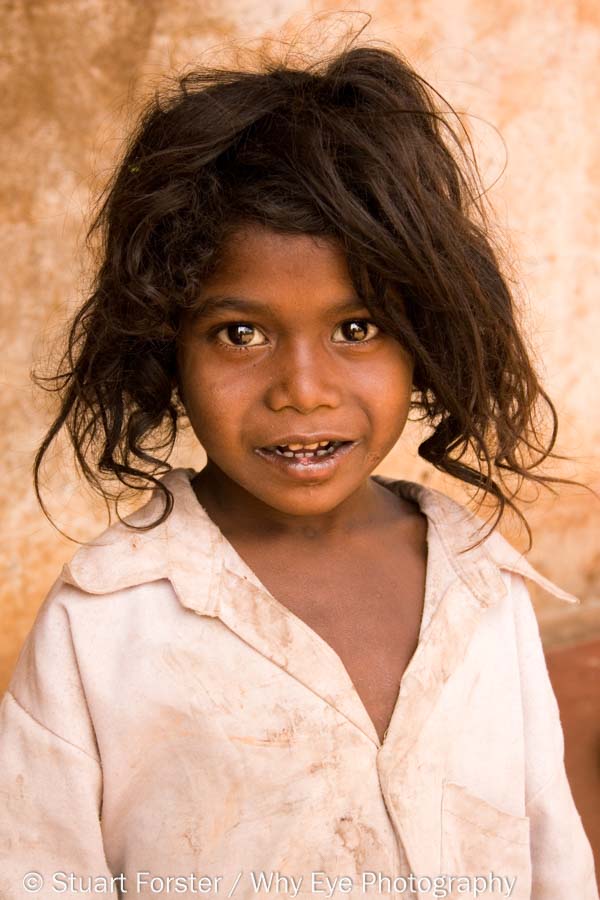 Portrait of a young girl with tussled hair from the Soliga tribe in Karnataka, India.
