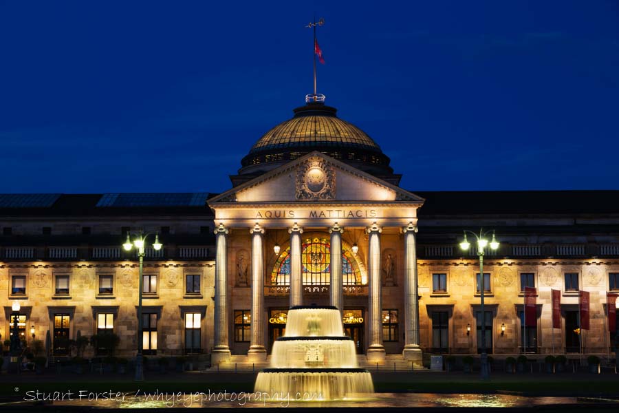Wiesbaden's Kurhaus and fountain at night.