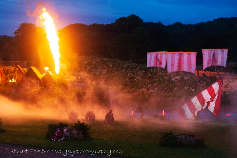 Pyrotechnics shoot a jet of fire into the evening sky during a performance of Kynren in North East England.