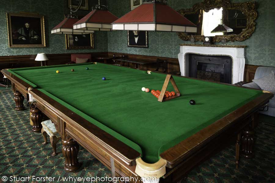 Oil paintings handg in frames around the Billiard table within the Billiard Room at Brocket Hall