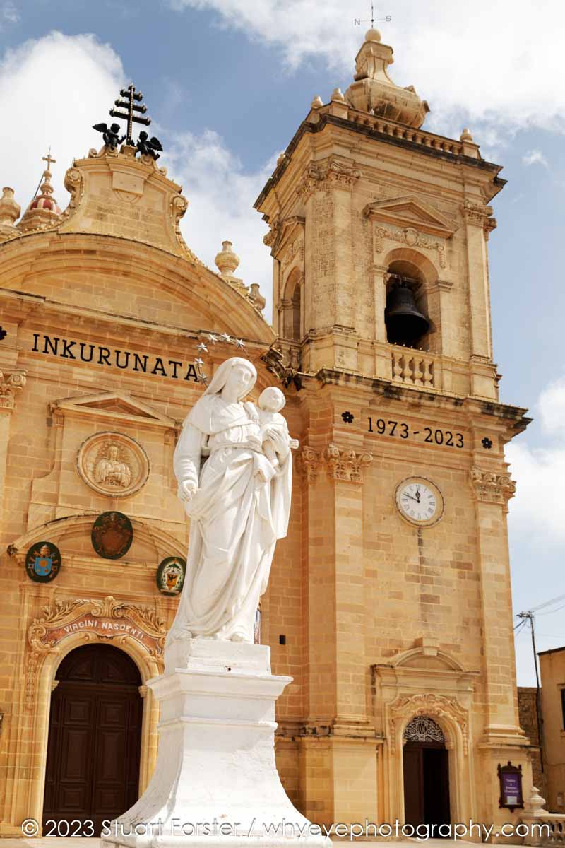 Statue of the Virgin Mary with the Infant Jesus outside of the Basilica of the Nativity of Our Lady in Xagħra on Gozo, Malta.